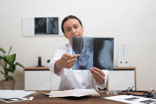 Preview: Female doctor speaks with patient online pointing finger at pathology on X-ray examination picture