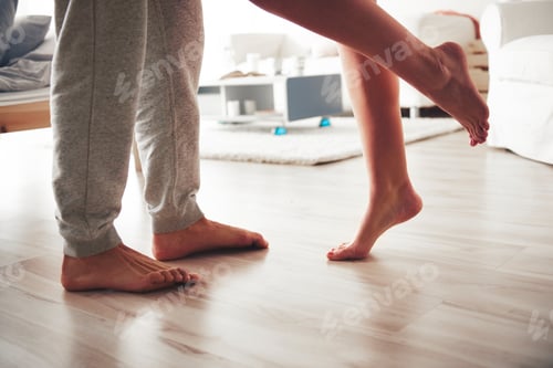 Preview: Couple standing face to face, woman leaning into man, low section