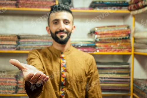 Preview: small shop owner indian man selling shawls at his store in arambol goa