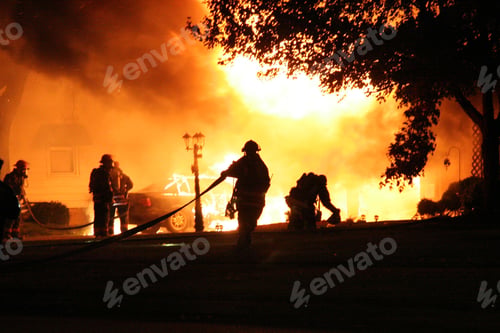Preview: View of firefighters trying to extinguish the fire at night