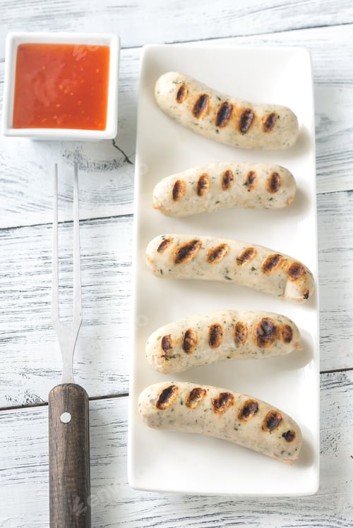 Preview: Grilled Sausages with Sauce on a Serving Plate
