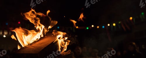 Preview: Fire with flames and bokeh lights. Bonfire with blurred people on night background.