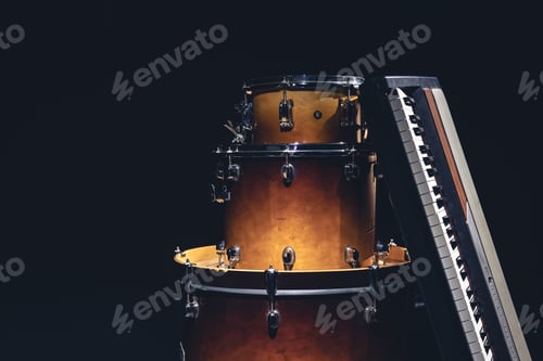 Preview: Drums and musical keys on a black background isolated.