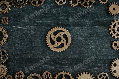 Preview: top view of vintage metal gears arranged in frame on dark wooden background