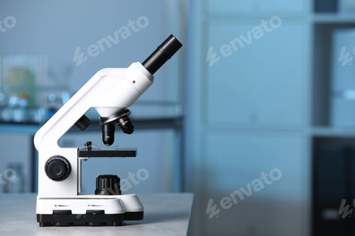 Preview: Modern medical microscope on gray table in laboratory, space for text