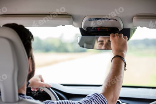 Preview: Mid adult man driving in car