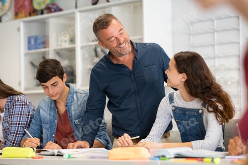 Preview: Professor helping college students in class during lesson