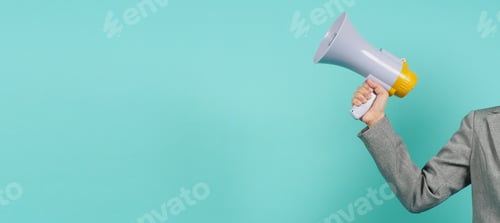 Preview: Hand is hold megaphone and wear grey suit on green or mint or Tiffany Blue background.