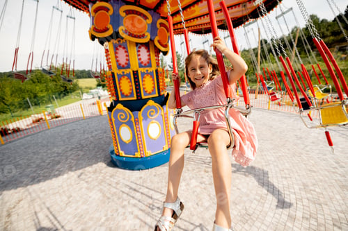 Preview: Kids riding on colorful amusement carousel