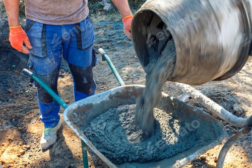 Preview: Builder pouring cement from a cement mixer