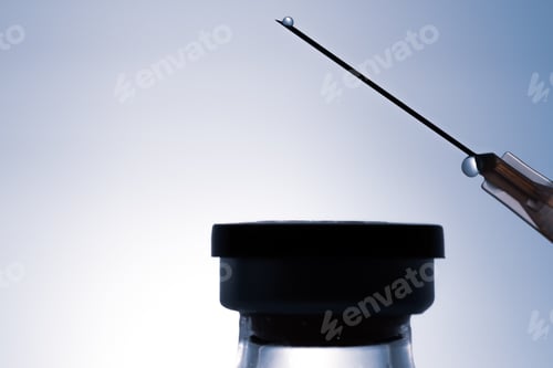 Preview: Bottle with solution for injection and syringe with drops on top