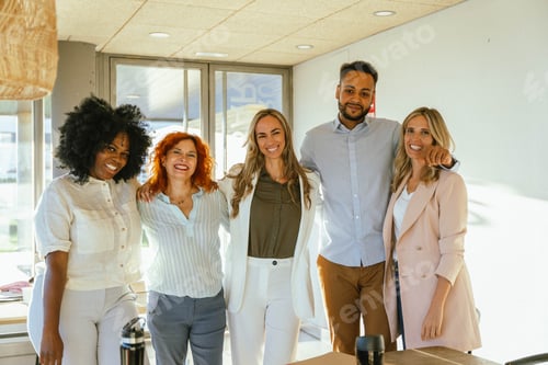 Preview: Multiethnic business team smiling while standing together in the office.