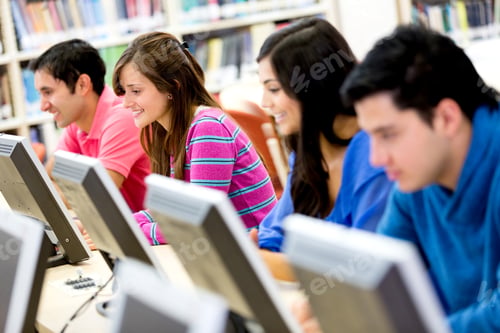 Preview: Group Of Young People Studying At The Library Using Computers
