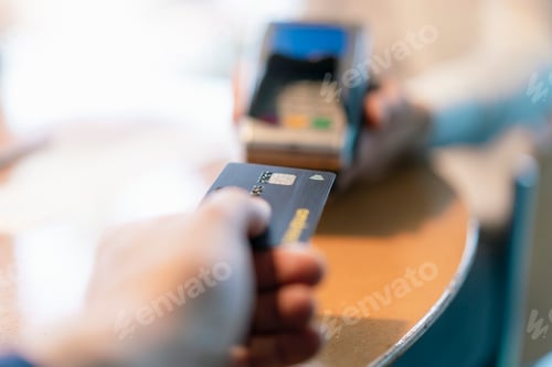 Preview: Man using credit card reader, close-up