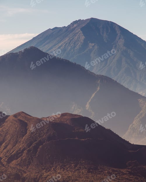 Preview: Vertical shot of Mount Batur and Mount Agung during the sunrise in Indonesia