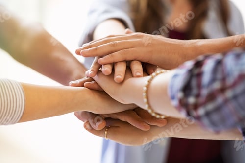 Preview: Young multiethnic friends stacking hands