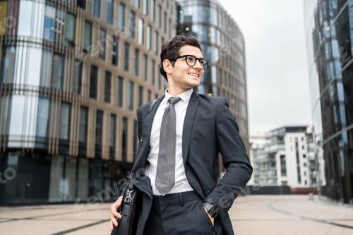 Preview: Businessman man with glasses goes to work in the office in a business suit