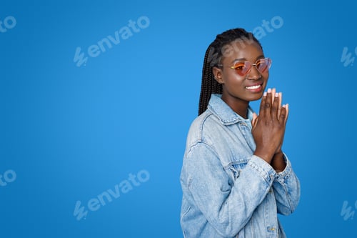 Preview: Smiling beautiful young african woman asking for something, copy space