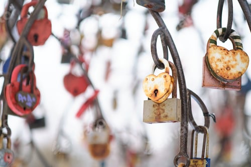 Preview: close up old rusty locks heart shaped on wire rope. Love lock on the bridge. tradition of hanging a