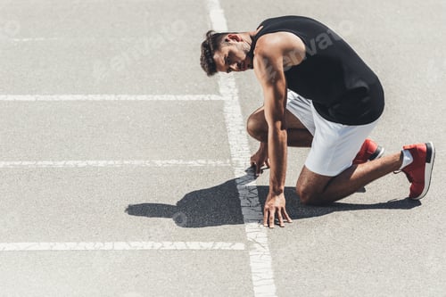 Preview: young sportsman on low start on running track