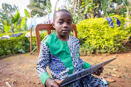 Preview: Portrait of an African child studying from the tablet, technology in Africa
