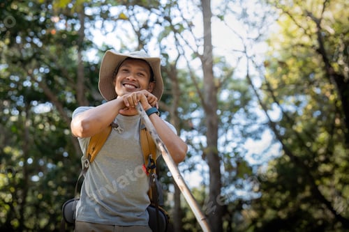 Preview: Young man asian trekking among trees with backpack, young man enjoy alone in forest. Camping