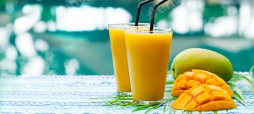 Preview: Fresh Tropical Fruit Smoothie Mango Juice and Fresh Mango on a Outdoor Tropical Background.