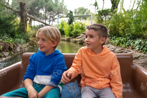 Preview: Children riding an amusement park attraction taking a boat ride