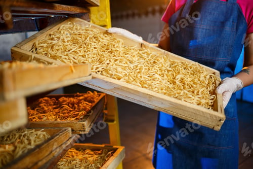 Preview: The girl works on the production of spaghetti. Making noodles. Pasta factory. Stage production