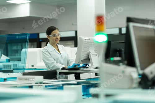 Preview: Joyful young researcher looking at screen of computer