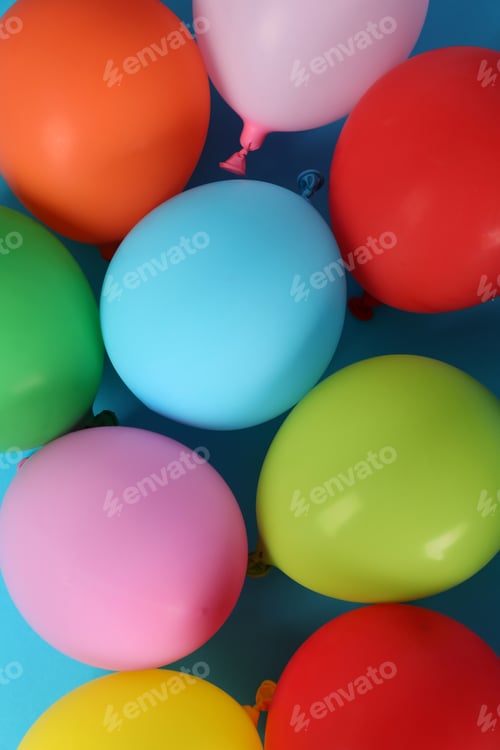 Preview: Multicolored balloons on blue background, top view
