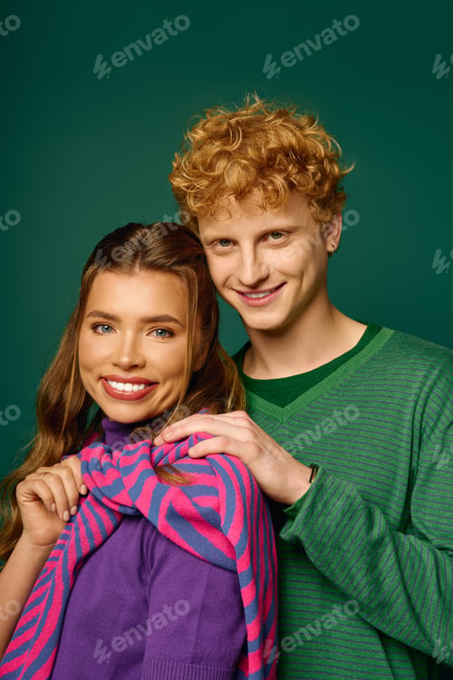 Preview: Young couple radiates love in vibrant outfits against a playful backdrop in an artistic setting