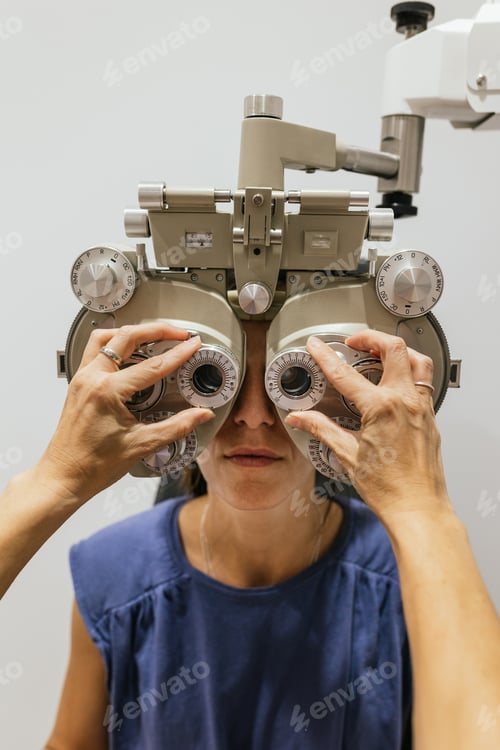 Preview: Woman Having Eye Exam with Phoropter