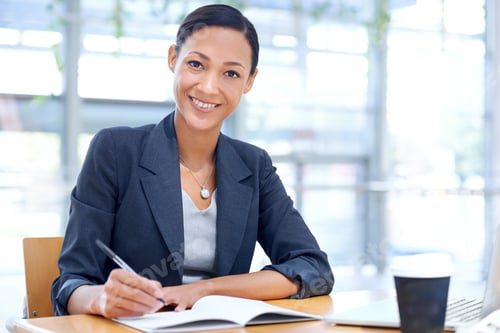 Preview: Taking minutes for the meeting. A businesswoman writing on a notebook while sitting in her office.