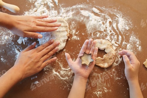 Preview: Family Baking: Hands of mother and child shaping cookie dough together