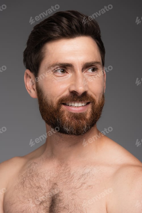 Preview: portrait of shirtless and happy man with hair on chest smiling isolated on grey