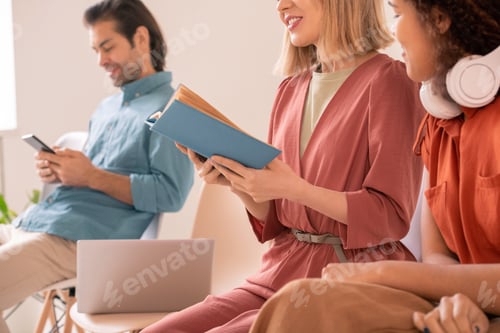 Preview: Woman sharing impressions by book with friend