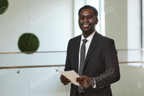 Preview: Smiling Businessman Holding Documents