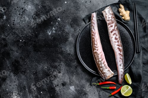Preview: Raw king klip, congrio fish. Black background. Top view. Copy space