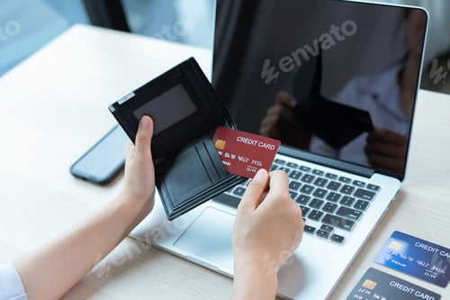 Preview: Business women hold credit cards To put information on the card to make payment via card, electronic