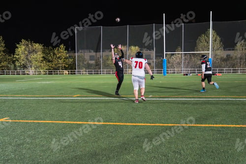 Preview: American football players competing for ball on field
