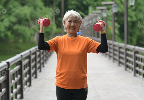Preview: Elderly woman exercising outdoors.