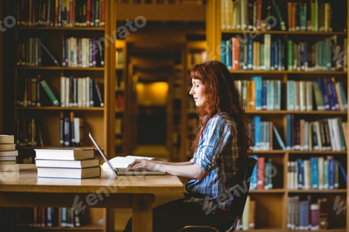 Preview: Mature student studying in library at the university