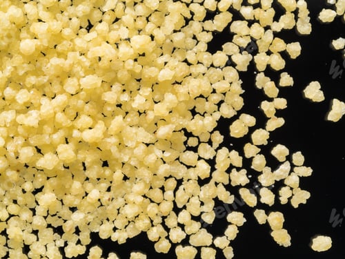 Preview: raw dry grains couscous on black background, close-up, top view