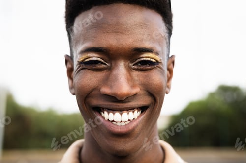 Preview: Happy African gay man smiling in front of camera