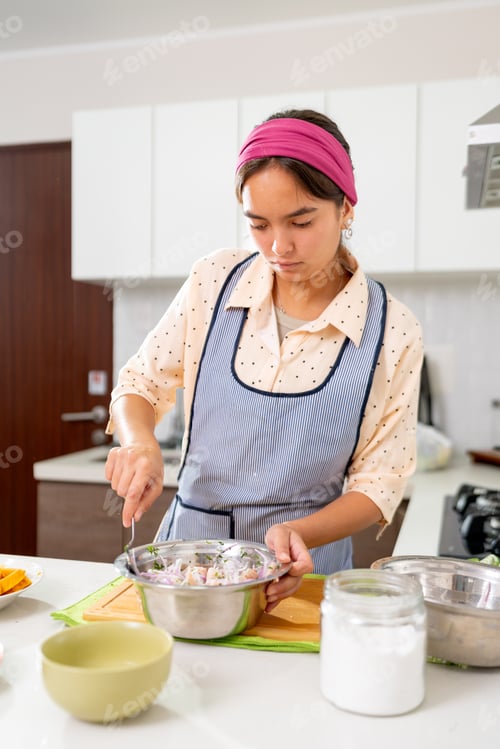 Preview: Young latin chef preparing delicious peruvian ceviche in a modern kitchen