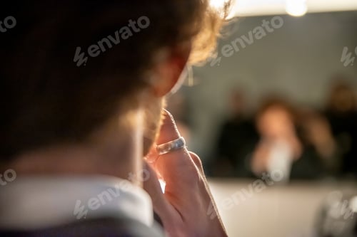 Preview: Person With Ring Reflected in Mirror With Others