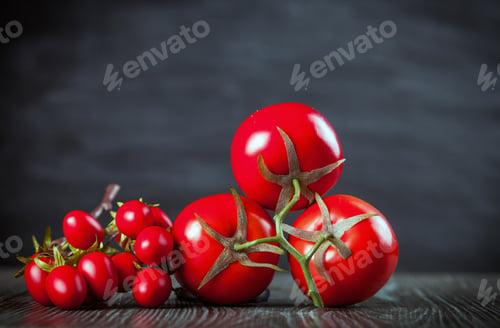 Preview: Various tomatoes on wooden table dark background front view