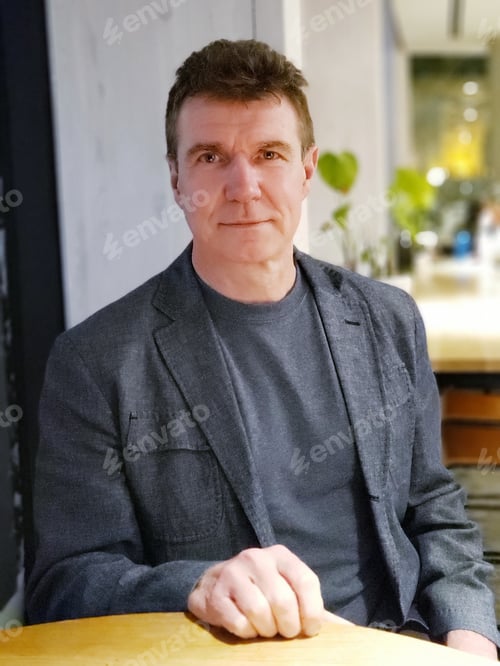 Preview: Older man looking at camera neatly shaved and professionally dressed