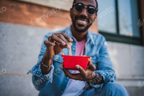 Preview: Man Enjoys Fries Outdoors in the City